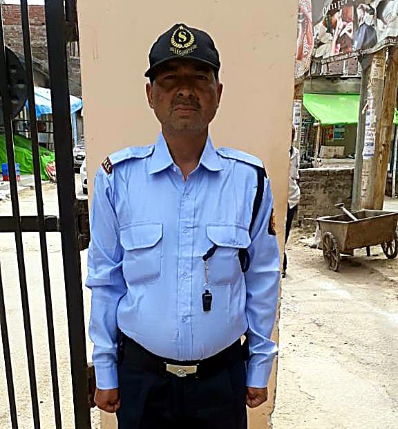 Modern Security Services guard on duty at a residential gate